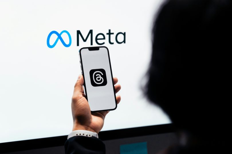 Meta's logo behind phone